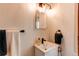 Bathroom with white vanity, neutral walls, modern faucet and towel holder at 3052 S Cherokee St, Englewood, CO 80110