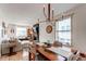 Bright dining room with hardwood floors, modern lighting, and open concept to living room with fireplace at 3052 S Cherokee St, Englewood, CO 80110
