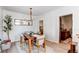 Cozy dining room features a wood table with seating and a modern chandelier at 3052 S Cherokee St, Englewood, CO 80110