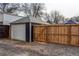 The property features a detached garage with a privacy fence, offering ample parking and storage at 3052 S Cherokee St, Englewood, CO 80110