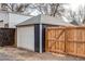 Detached one car garage with a side gate leading to the backyard at 3052 S Cherokee St, Englewood, CO 80110