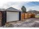 View of detached one-car garage and wood fence in the backyard at 3052 S Cherokee St, Englewood, CO 80110