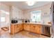 Well-lit kitchen features stainless steel appliances and wood cabinets at 3052 S Cherokee St, Englewood, CO 80110
