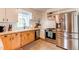 Well-lit kitchen features stainless steel appliances, white cabinets, and tile backsplash at 3052 S Cherokee St, Englewood, CO 80110