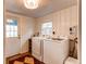 Convenient laundry room with washer, dryer and tiled flooring at 3052 S Cherokee St, Englewood, CO 80110