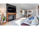 Bright living room with a fireplace, comfortable seating, and an adjacent dining area at 3052 S Cherokee St, Englewood, CO 80110