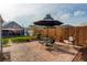 Brick patio featuring an umbrella table, chairs, and a wooden fence at 3052 S Cherokee St, Englewood, CO 80110