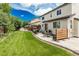 Wide backyard featuring a lush lawn, patio with seating, grill and hot tub with pergola at 11725 Helena St, Commerce City, CO 80022