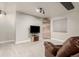 Cozy basement living area with plush carpeting, a TV, and inspirational wall decor at 11725 Helena St, Commerce City, CO 80022