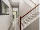 Inviting entryway with wood floors, stairs, and elegant mirror, leading to dining and light-filled spaces at 11725 Helena St, Commerce City, CO 80022