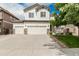 Charming two-story home with a three-car garage, stone accents, and manicured lawn at 11725 Helena St, Commerce City, CO 80022