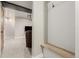 Basement entryway with a bench and hanging hooks, lit by track lighting at 11725 Helena St, Commerce City, CO 80022