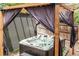 Backyard hot tub under wood pergola with privacy curtains at 11725 Helena St, Commerce City, CO 80022