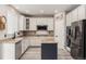 Modern kitchen with stainless steel appliances, granite countertops, and an island with extra storage at 11725 Helena St, Commerce City, CO 80022