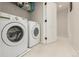 Functional laundry room with modern washer and dryer, offering convenience and efficiency at 11725 Helena St, Commerce City, CO 80022