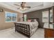 Comfortable main bedroom with plush bedding, window views, and warm lighting, showcasing a relaxing retreat at 11725 Helena St, Commerce City, CO 80022