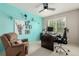 Bright office features a ceiling fan, turquoise wall, and comfortable chair at 11725 Helena St, Commerce City, CO 80022