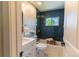 Updated bathroom with marble floors, blue tile and modern fixtures at 9410 Perry St, Westminster, CO 80031