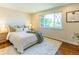 Bedroom with hardwood floors, a large window, and stylish decor at 9410 Perry St, Westminster, CO 80031