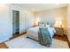 Bedroom featuring a queen bed, wood floors, and closet with shelving at 9410 Perry St, Westminster, CO 80031