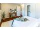 Bedroom with hardwood floors, closet, and a stylish console table at 9410 Perry St, Westminster, CO 80031