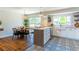 Open-concept kitchen and dining area with modern appliances, a stylish island, and hardwood floors at 9410 Perry St, Westminster, CO 80031