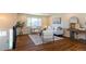 Inviting living room with hardwood floors, stylish seating, and a large window for natural light at 9410 Perry St, Westminster, CO 80031