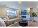 Inviting living room with neutral colors, large window, and modern entertainment center at 9410 Perry St, Westminster, CO 80031