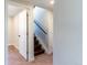 A stairwell with carpet, wooden steps, and a handrail leads to the upper level of the home at 9410 Perry St, Westminster, CO 80031
