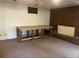Spacious basement area with brick fireplace, carpet and a small window at 7127 Otis St, Arvada, CO 80003