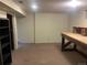 A versatile basement space with carpet and exposed brick accents at 7127 Otis St, Arvada, CO 80003