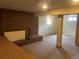 Open basement with a brick fireplace and neutral carpeting for a cozy feel at 7127 Otis St, Arvada, CO 80003