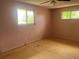 Bedroom showcasing two windows and a neutral color scheme at 7127 Otis St, Arvada, CO 80003