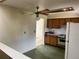 Kitchen featuring a white refrigerator and wood cabinets at 7127 Otis St, Arvada, CO 80003