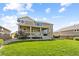 Spacious backyard featuring a covered deck, patio area, and well-maintained lawn at 2669 Red Bird Trl, Castle Rock, CO 80108