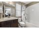 Clean bathroom featuring a shower/tub combo, a vanity with sink, and a large mirror at 2669 Red Bird Trl, Castle Rock, CO 80108