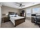 Bright bedroom with large windows, ceiling fan, desk, and TV, offering comfort and functionality at 2669 Red Bird Trl, Castle Rock, CO 80108