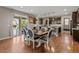 Elegant dining room with a large table, stylish chairs, and a sliding door to the outdoor deck, ideal for Gathering dinners at 2669 Red Bird Trl, Castle Rock, CO 80108