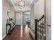 Stunning entryway with hardwood flooring, a decorative console table, and an adjacent staircase adding charm at 2669 Red Bird Trl, Castle Rock, CO 80108