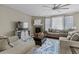 Cozy living room featuring a fireplace, comfortable seating, and a large window for natural light creating a relaxing atmosphere at 2669 Red Bird Trl, Castle Rock, CO 80108