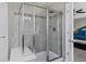 Luxurious tiled shower with glass enclosure and built-in bench, enhancing the modern bathroom's appeal at 2669 Red Bird Trl, Castle Rock, CO 80108