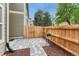 Private backyard area featuring a stone patio, privacy fence, and landscaping, ideal for relaxing outdoors at 9110 Gale Blvd # 3, Thornton, CO 80260