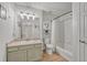Bright bathroom featuring a vanity with stylish sink, wooden floors, and shower with white subway tile at 9110 Gale Blvd # 3, Thornton, CO 80260