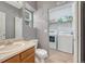 Bathroom with a sink, toilet, laundry area, and a gray color palette at 9110 Gale Blvd # 3, Thornton, CO 80260