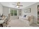 Bright bedroom with a ceiling fan, desk, large window, and a trundle bed with storage drawers at 9110 Gale Blvd # 3, Thornton, CO 80260