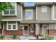 Charming two-story townhome with brick accents, inviting front porch, and manicured landscaping at 9110 Gale Blvd # 3, Thornton, CO 80260