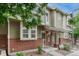 Charming two-story townhome with brick accents, inviting front porch, and manicured landscaping at 9110 Gale Blvd # 3, Thornton, CO 80260