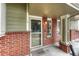 Inviting front porch featuring a screen door and charming brick accents at 9110 Gale Blvd # 3, Thornton, CO 80260