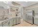 Well-lit kitchen featuring modern, stainless steel appliances and updated cabinets and countertops at 9110 Gale Blvd # 3, Thornton, CO 80260