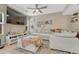 Bright living room with large windows, ceiling fan, and comfortable sectional sofa at 9110 Gale Blvd # 3, Thornton, CO 80260
